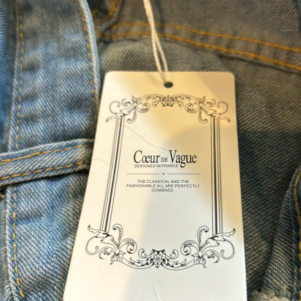 Large light blue soft denim cuffed jean shorts with shredded holes. - Picture 4 of 4